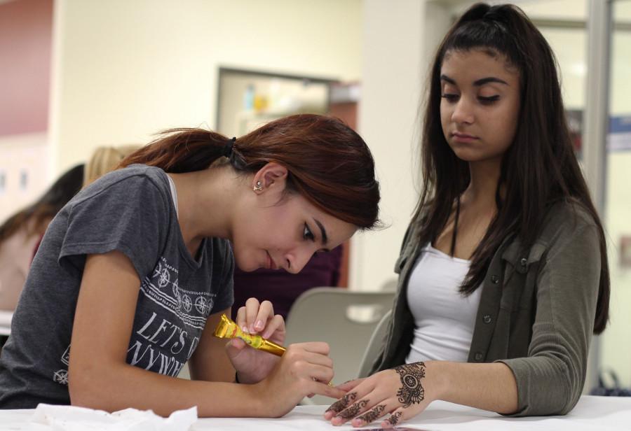 During the Muslim Student Association event after school on Nov. 4, sophomore Sandy Kaur gets a henna tattoo. The fundraiser aimed to bring in money in order for the club, which recieves no funding otherwise, to host future cultural events and lower the cost of MSA t-shirts.
