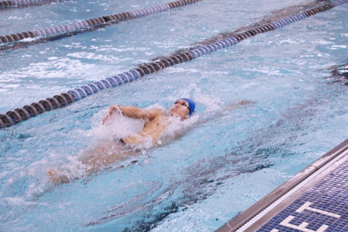 Junior Jihoon Jung swims the backstroke leg of his 200 individual medley from lane 1. Jung won the event with a time of 1:59.93. 