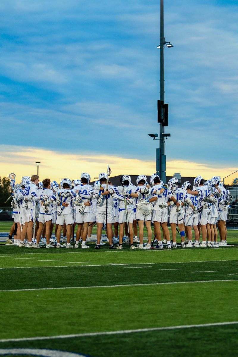 The+HSE+Boys+Varsity+Lacrosse+team+holds+each+other+in+unity+before+the+game
